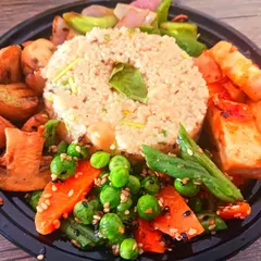 A wholesome and colourful millet bowl, artfully arranged with sautéed mushrooms, crisp vegetables, and pan-fried tofu. This is a perfect template for a quick, healthy, and complete meal.
