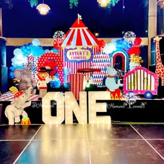 Step right up to a world of fun with my vibrant carnival-themed parties. This first birthday stage features a classic red and white striped circus tent backdrop, marquee letters, and playful animal character cutouts, ready for the main event.