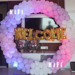 A circular balloon arch is a perfect way to welcome guests. For this event, I created a beautiful pink, purple, and white balloon ring and placed large gold foil "WELCOME" balloons in the center to greet everyone in style.