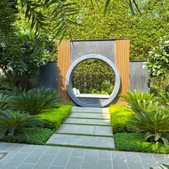 A unique circular seating nook nestled within a lush garden at a private residence in Kanpur. This feature acts as a tranquil focal point, demonstrating our passion for creating intimate, artistic spaces for quiet reflection and connection with nature.