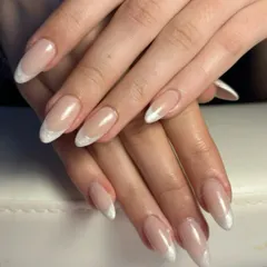 A modern take on a classic. This look features a subtle, shimmery white tip on a beautifully shaped almond nail, offering a fresh and elegant alternative to the traditional French manicure.
