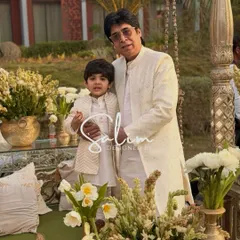 A heartwarming photo of a father and son in matching custom-designed ivory kurtas and jackets. I love creating coordinated outfits for family members to share on special occasions.