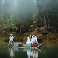 Drifting on a calm, misty lake in a rustic boat. This pre-wedding scene is straight out of a storybook, offering a serene and incredibly romantic setting to capture your connection.