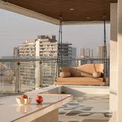 Another view of the terrace, showing the sleek marble table and the reversible swing, a perfect setup for everything from quiet mornings to lively evenings.