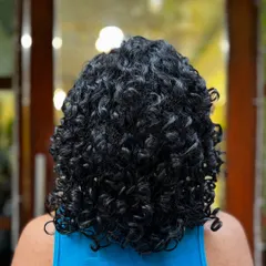 This client was ready for the big chop! We went from long, weighed-down hair to a short, voluminous style that lets her tight curls spring to life.