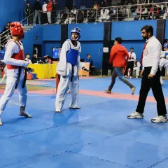 In the ring, ensuring a fair and disciplined match. My experience as a referee helps me train my students to compete with integrity.