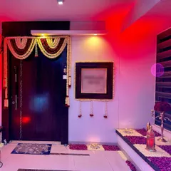 The festive feeling starts at the door. For this home celebration, we decorated the entrance with traditional flower garlands and a path of scattered rose petals and candles.