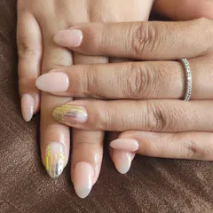 A simple nude manicure with two accent nails featuring a shattered glass effect using iridescent foils.