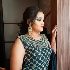 A student looking elegant after a class demonstration where I created this green halo-eye makeup look. It's rewarding to see them feel confident and beautiful.