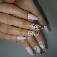 A beautiful floral design on a white base, paired with soft pink nails for a romantic and classic bridal or everyday look.