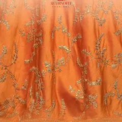 A close-up of the beautiful golden embroidery on my orange silk lehenga. I love how the threadwork catches the light, adding a touch of royalty.