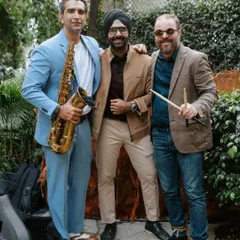 Me with my talented collaborators, a saxophonist and a percussionist. We work together as a team to create a cohesive and electrifying live performance.