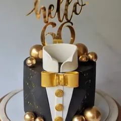 Starting the year in style with this tuxedo cake. The black and gold design is perfect for a sophisticated "Hello 60" birthday celebration.