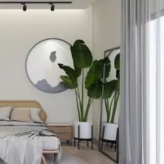This Scandinavian-inspired bedroom is all about creating a sense of calm and stillness. The rattan headboard, light wood tones, and simple artwork, paired with a large plant, bring natural elements indoors for a restful atmosphere.