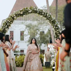 The bride's grand entrance, with her proud and happy bridesmaids cheering her on as she walks down the aisle.