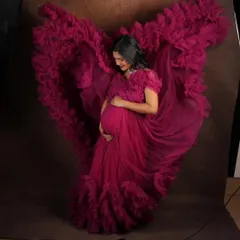 Feel like a goddess in this magenta flying gown, designed to make your maternity photoshoot absolutely breathtaking. The way the ruffled trail catches the air creates stunning, dynamic images that you will cherish forever.