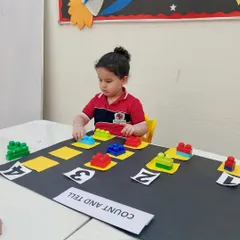 With intense focus, this child works on her counting and matching skills. Our play-based math activities are designed to hold a child's attention while they learn important foundational concepts.