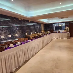 An angled shot of a long buffet line, showcasing the clean and organized arrangement. This setup is perfect for formal banquets and wedding receptions.