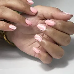 For a touch of simple art, I created this pink and white wave design over a clean Russian manicure base. It adds a bit of personality while still maintaining a very elegant and understated look.