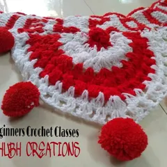 Add a festive touch to your home with a handmade crochet toran. This red and white piece, complete with fluffy pom-poms, is a fun project we often make for festivals like Diwali.
