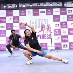 Kicking off a marathon with a dynamic warm-up is crucial for performance and safety. Here, I'm guiding runners through stretches and movements to get their muscles ready and their spirits high for the 'Run for Happiness' event.