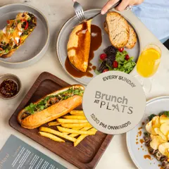 A table laden with some of our brunch favorites, including the Bánh Mì and Braised Lamb Omelette. This is a typical sight on a Sunday at Plats.
