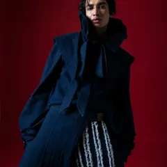 Focusing on the dramatic collar and the model's intense expression. This is where fashion photography becomes character study.