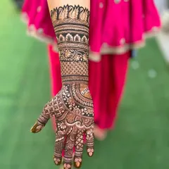 A full-arm design with a deep, consistent stain from the elbow to the fingertips. The name 'Utsav' is clearly visible on the palm.