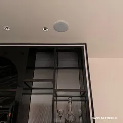 Notice the small, circular grille in the ceiling above the bar? That is a high-performance Starke Sound in-ceiling speaker. This installation in a Delhi lounge provides rich background music and party sound from a source that is completely unobtrusive, preserving the room's clean, modern aesthetic.