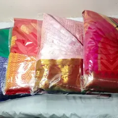 A batch of sarees, all pleated and packed, ready for a client. This is the final step of my service, ensuring your sarees are protected and easy to manage.
