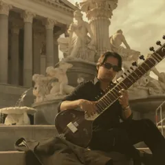 Playing my sitar in Vienna, with the city's grand architecture in the background. Taking my music to different parts of the world is a constant source of inspiration.