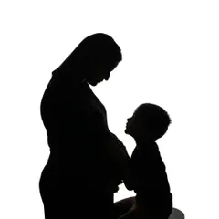 A beautiful silhouette of a mother and her older child sharing a quiet moment with the baby bump. It's a touching portrait of the bond between siblings before they've even met.