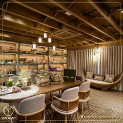 The elegant interior of the Madihah Ahmedabad store, designed to make you feel welcome and inspired. The shelves are filled with curated hampers and decor pieces.