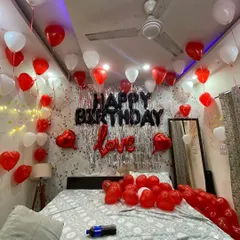A wider angle of the red, white, and black themed birthday room. You can see how the balloons fill the space, creating an immersive and festive environment from the moment your loved one walks in.