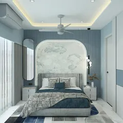 Soft hues create soft vibes. This bedroom uses a cool blue color palette with a fluted wall panel behind the bed and a custom arched headboard with delicate wallpaper to create a calming and dreamy space.