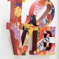 Another angle of 'Love Unleashed,' highlighting its three-dimensional form. The collage, bursting with color and iconic symbols, reflects the multifaceted nature of love in modern times.