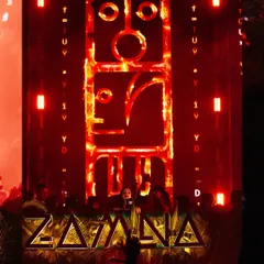The massive, intricate stage design for Zamna Festival, glowing red. This shot highlights the incredible production value of the electronic music events I cover.