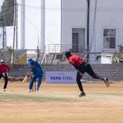 We bring corporate sports to life with professional tournament management. This action shot from the Indian Corporate Cricket League shows our on-field execution, complete with prominent branding for sponsors like Tata Steel.