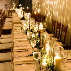 We transformed this space into a warm and intimate dining experience. A long table setting glows under the light of dozens of candles, creating a sophisticated and memorable atmosphere for an anniversary or special dinner party.