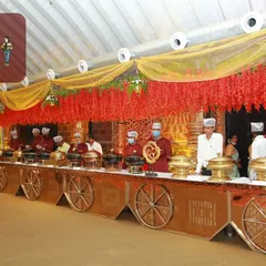 My team excels at creating beautiful, themed buffet counters. This setup, with its intricate chariot wheel designs and warm lighting, shows how I blend delicious food with stunning presentation for a royal wedding feel.
