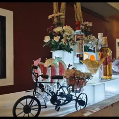 A closer look at our house party setup. The decorative tricycle holding cocktails and the illuminated risers add a touch of professional flair to a home setting.