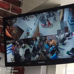 A four camera split screen monitoring a barber shop, covering all the chairs and the waiting area.