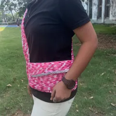 Side view of the crochet messenger bag. The strap is thick and sturdy so it's comfortable to wear all day.
