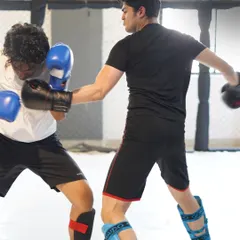 A snapshot from our controlled sparring sessions. Here, two students practice their kickboxing technique, applying what they've learned in a safe and supervised environment.