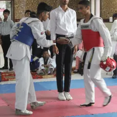 Respect before the fight. Two competitors shake hands before their match at the Warriors Cup, showing the sportsmanship that is central to Taekwondo.