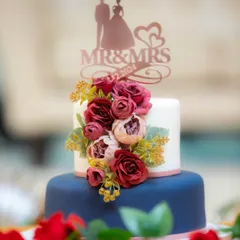 A client's photo of the navy and burgundy wedding cake. I love how the colors pop against the red roses on the table.