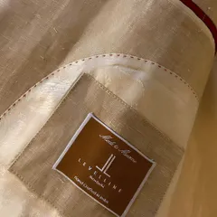 The inside of a bespoke blazer tells a story of craftsmanship. Here you can see our hand-crafted label, the luxurious lining, and the fine internal stitching.