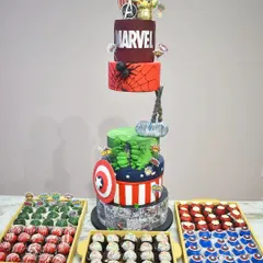 A gravity-defying Marvel-themed cake that stands over five feet tall. Each tier represents a different Avenger, from Captain America's shield to Thor's hammer, all part of an epic dessert display for a true fan.