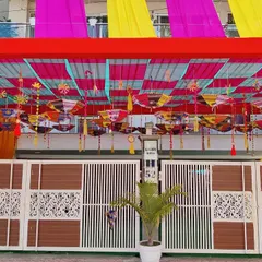 A close-up of the intricate ceiling work inside the entrance tent. We use colorful fabric strips and hang decorative items like small umbrellas to create a rich, traditional feel.