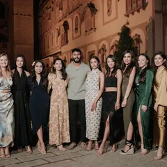 The bride and groom with their wonderful bridesmaids, all gathered for the pre-wedding welcome dinner.